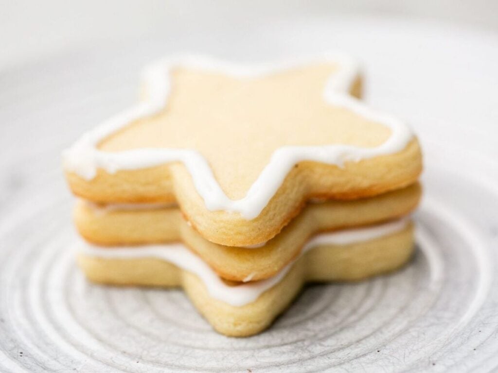 A stack of sourdough discard cut out sugar cookies sitting on a table.