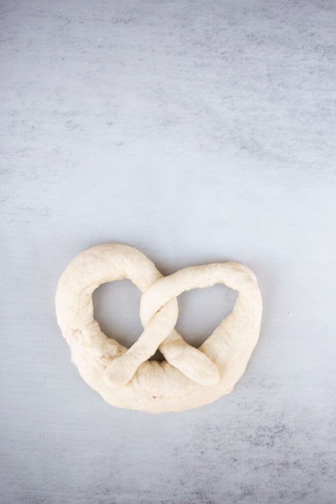 sourdough pretzels being shaped before boiling