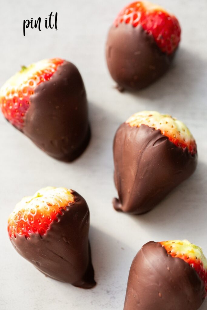 a group of chocolate covered strawberries on a table 