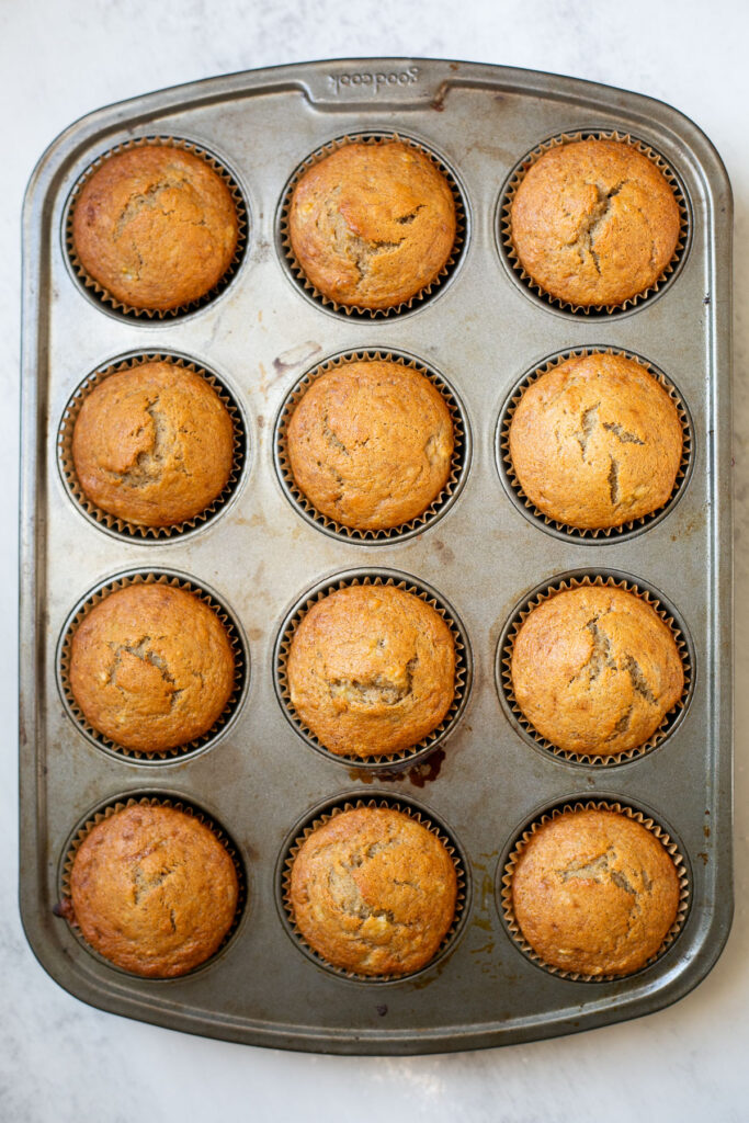 sourdough discard banana muffins in a muffin tin after baking