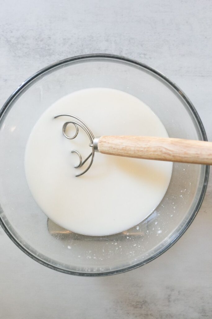 water and sourdough starter mixed together in a bowl