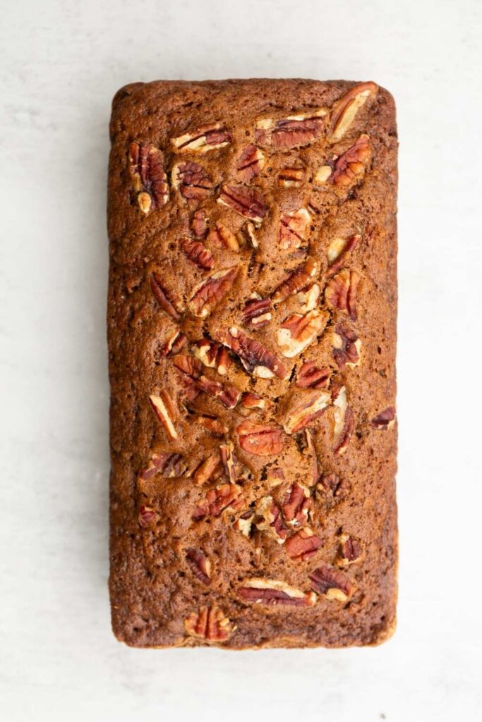moist and tender sourdough discard zucchini bread with pecans on top