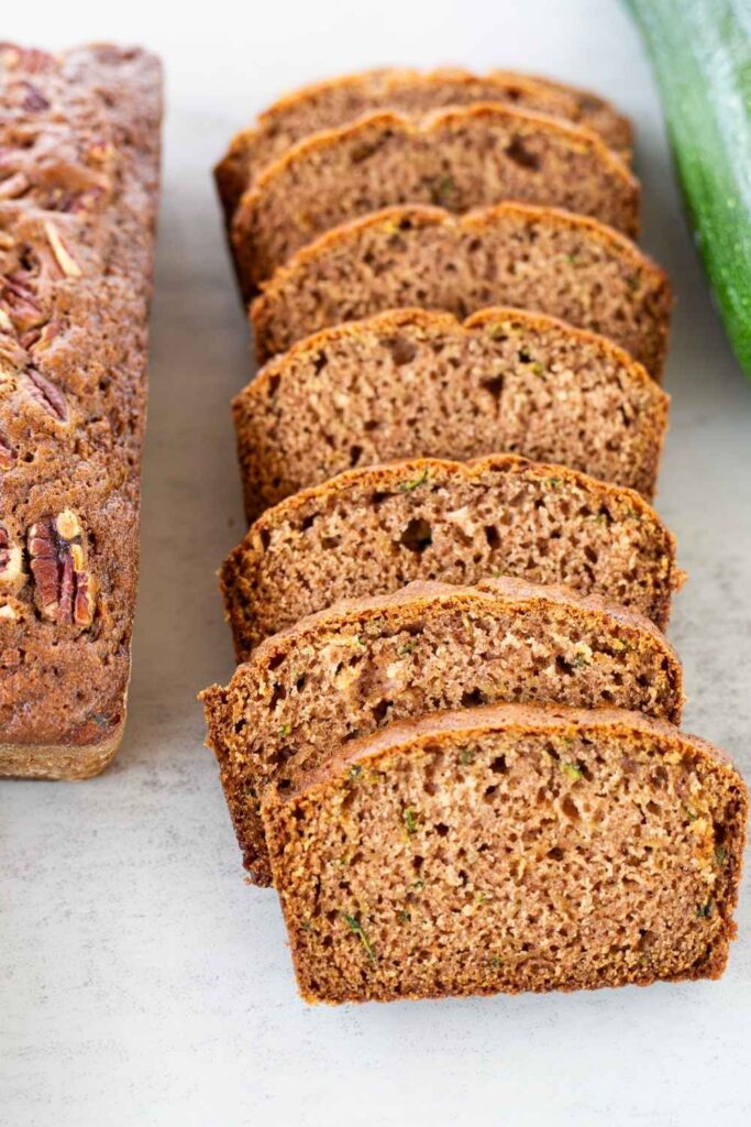 slices of sourdough discard zucchini bread on a table.