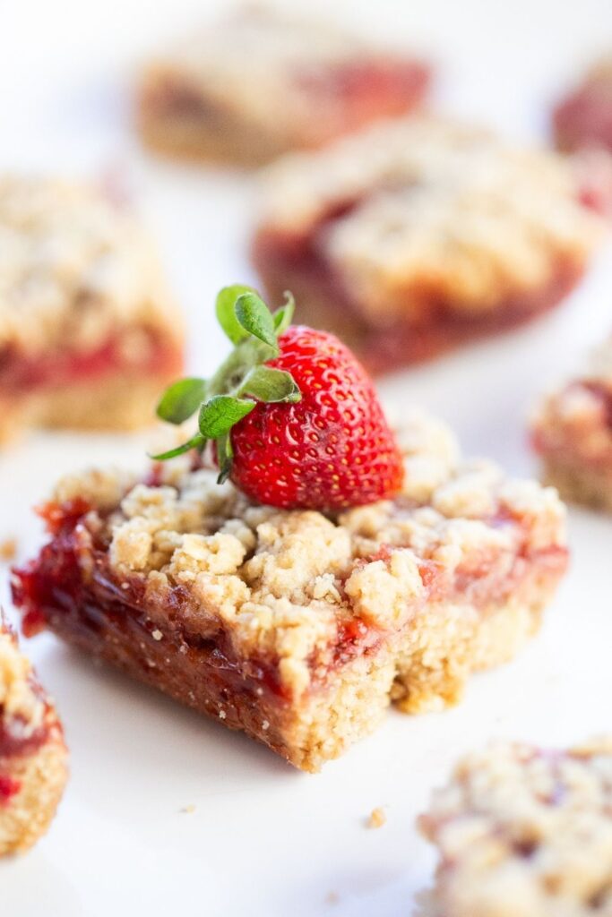 sourdough discard strawberry crumb bars with a strawberry on top