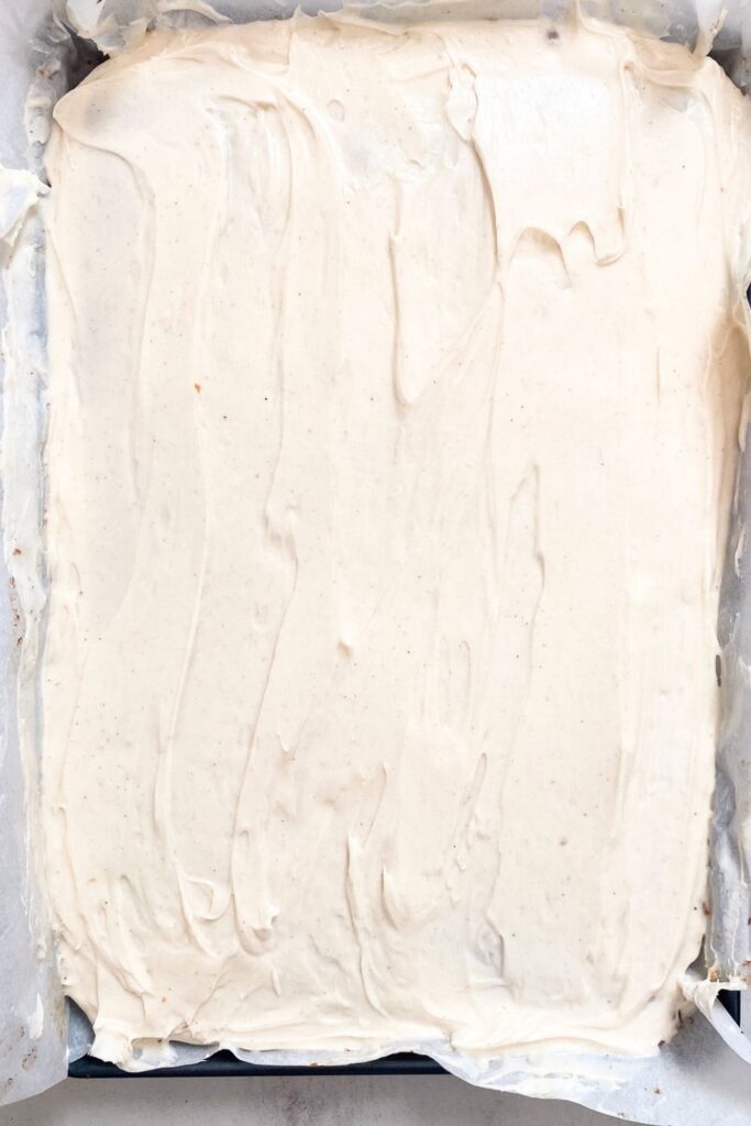 sourdough discard pumpkin bars in jelly roll pan with cream cheese frosting