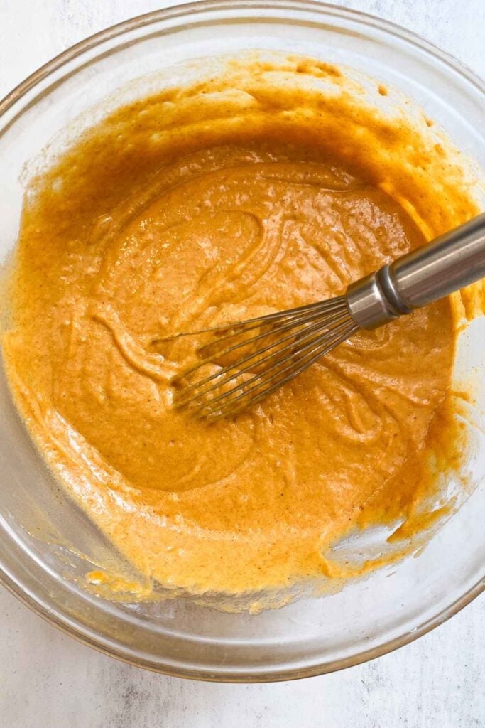 wet ingredients for sourdough discard pumpkin bars being mixed into a bowl.
