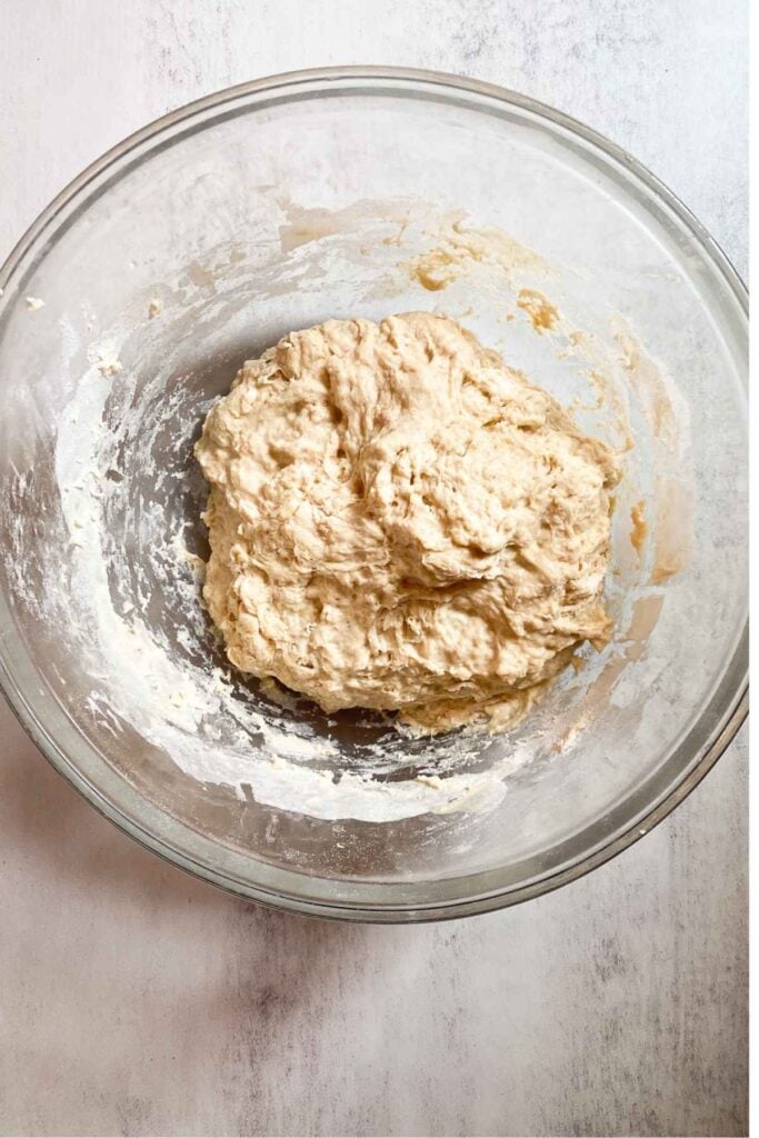 Ingredients for sourdough maple bread in a bowl: flour, maple syrup, vanilla, maple extract and salt.