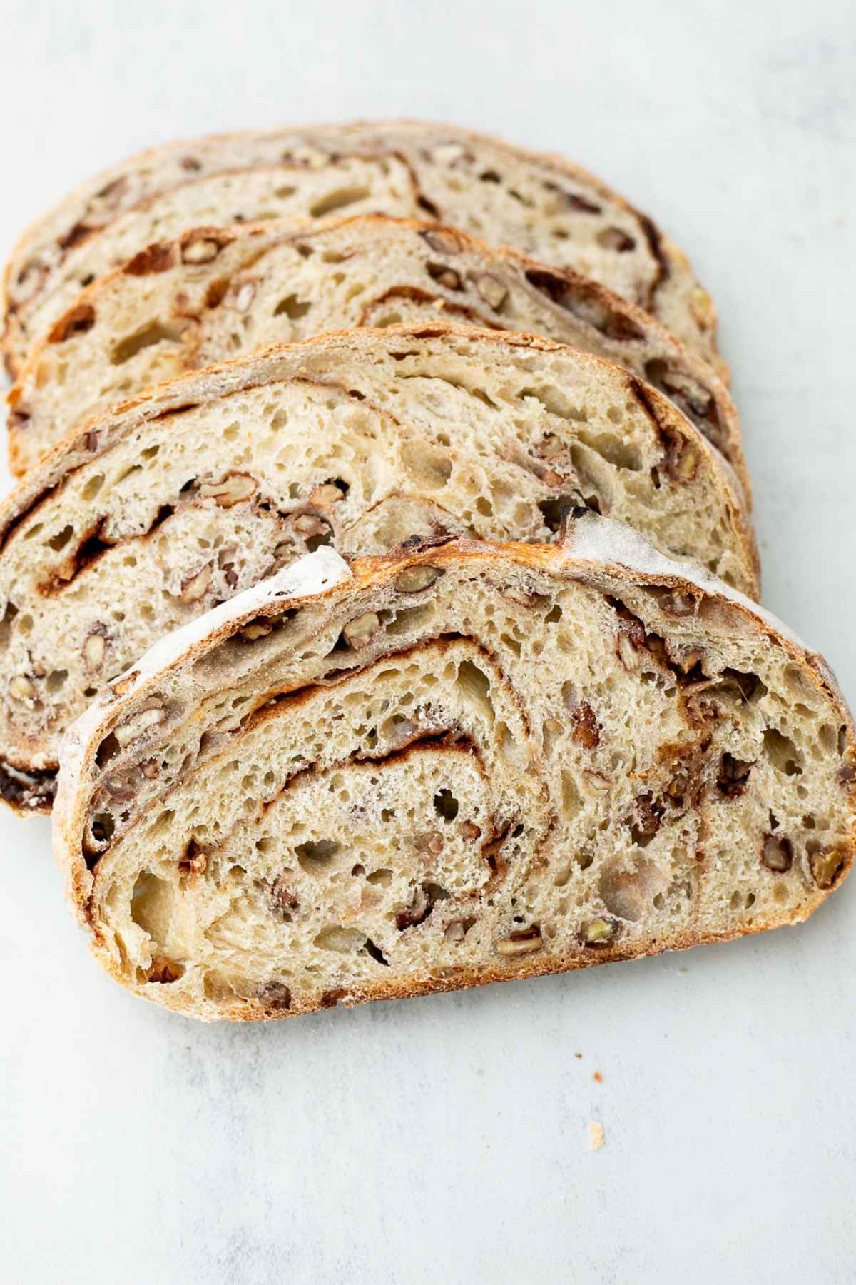 Slices of sourdough maple pecan bread on a tray.